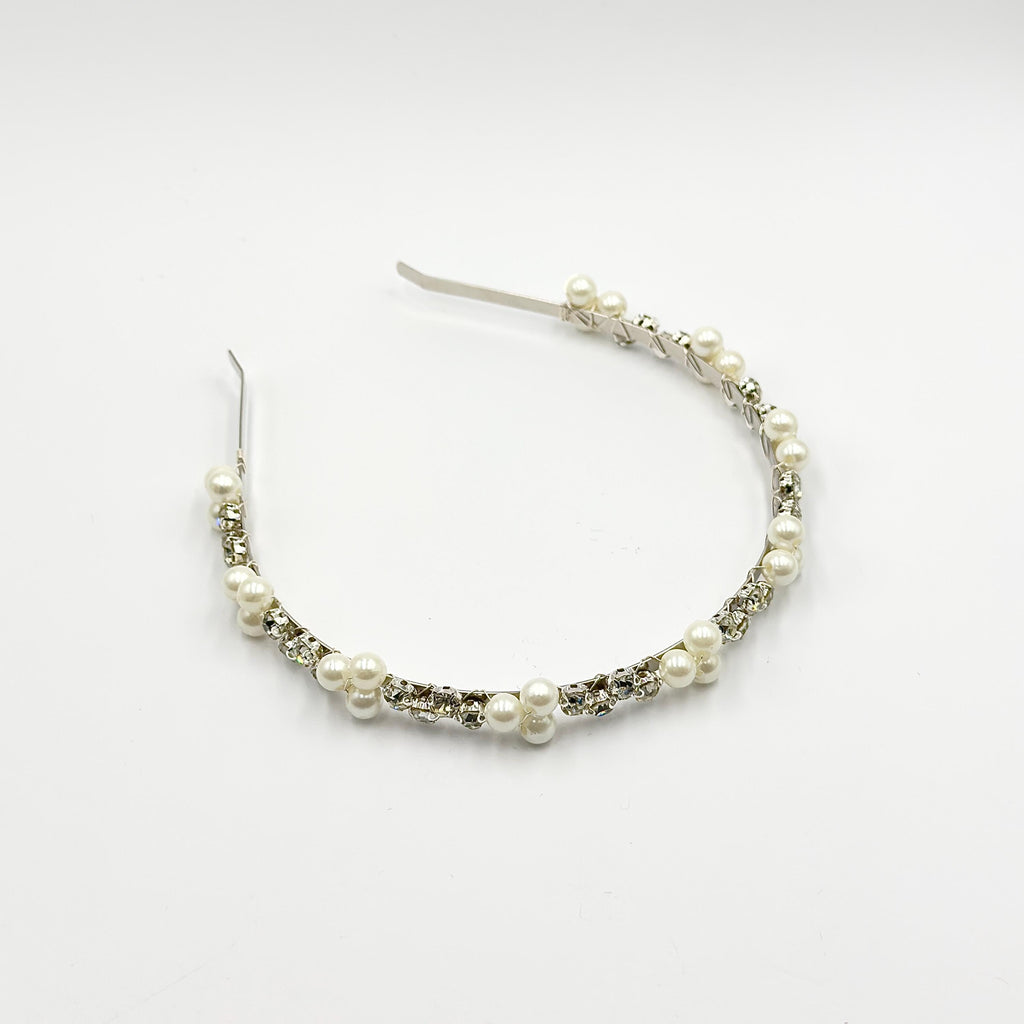 Required overhead view of the complete headband on a neutral background, showing its shape and the distribution of pearl groups along the stone row.