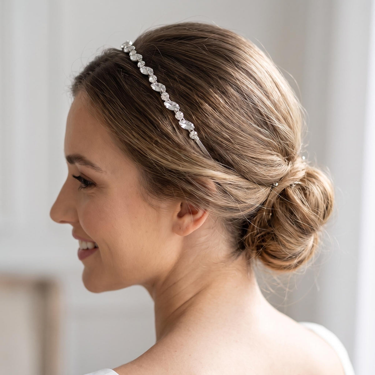 Required side or rear view of the open ends and inner surface, showing the headband construction, silver-tone finish and attachment of the stone row.