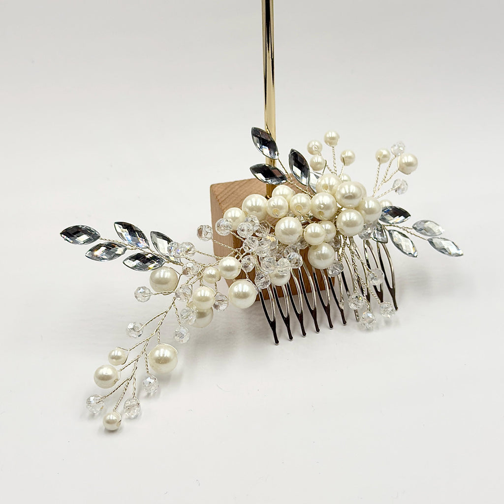 Required close-up of the central pearl cluster, transparent faceted beads and clear leaf elements, focusing on their surfaces and handmade construction.