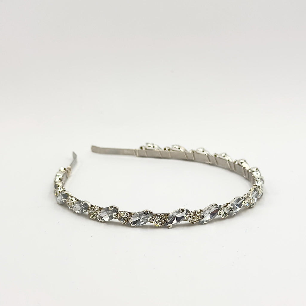 Required overhead view of the complete headband on a neutral background, showing its shape, width and the even distribution of both stone forms.