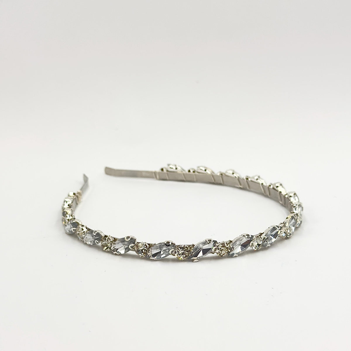 Required overhead view of the complete headband on a neutral background, showing its shape, width and the even distribution of both stone forms.